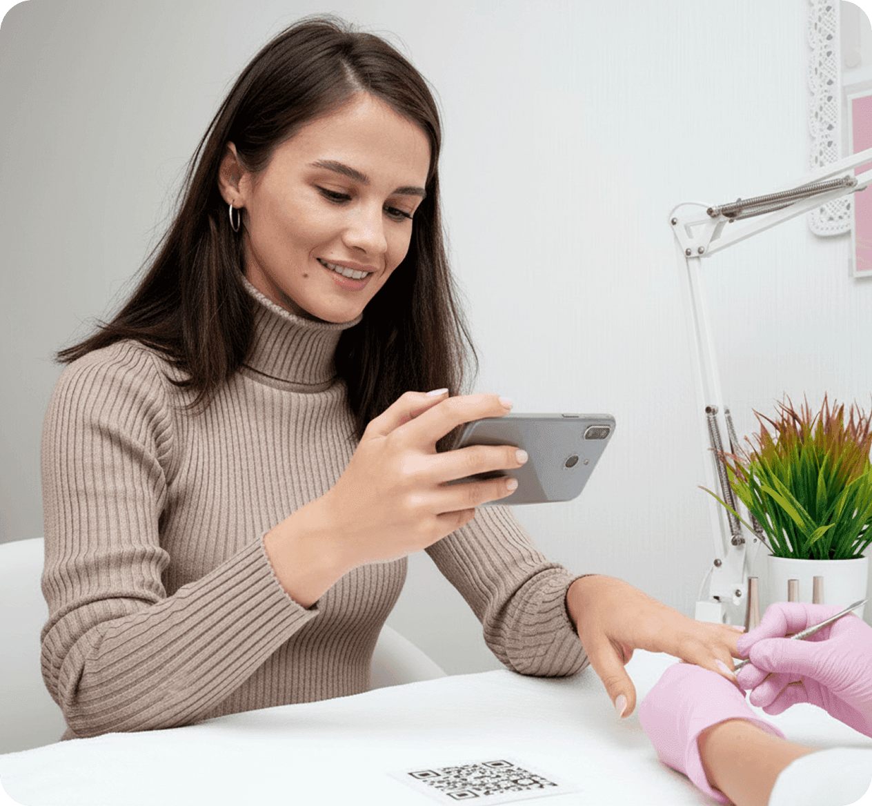Customer using phone with QR code at cafe